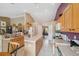 Spacious eat-in kitchen with an island, white appliances, and light wood cabinets at 13238 Asbury St, Spring Hill, FL 34609