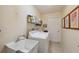 Laundry room with tile floors, a utility sink, and a washer and dryer at 13238 Asbury St, Spring Hill, FL 34609