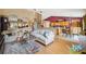 Spacious living room with hardwood floors, comfortable seating, and an open layout leading to the dining area at 13238 Asbury St, Spring Hill, FL 34609