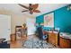 Bright office space featuring a ceiling fan, desk, and laminate floors at 13238 Asbury St, Spring Hill, FL 34609