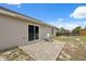 Home exterior featuring a concrete patio and sliding glass door at 13238 Asbury St, Spring Hill, FL 34609