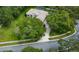Aerial view of a home surrounded by mature trees in a residential neighborhood at 13807 Eagles Rock Ct, Hudson, FL 34667