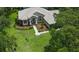 Aerial view of a home with a lush front yard, manicured landscaping, and mature trees at 13807 Eagles Rock Ct, Hudson, FL 34667