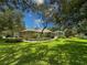 Expansive backyard featuring a screened-in lanai and lush landscaping at 13807 Eagles Rock Ct, Hudson, FL 34667