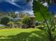 Inviting backyard area featuring a screened-in pool and lush landscaping for outdoor enjoyment at 13807 Eagles Rock Ct, Hudson, FL 34667