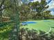 Outdoor basketball court with green and blue playing surface behind a chain link fence at 13807 Eagles Rock Ct, Hudson, FL 34667