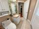 Well-lit bathroom with single sink, tile floor, and a view into the closet at 13807 Eagles Rock Ct, Hudson, FL 34667