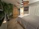 Comfortable bedroom with carpet floors, a decorative ceiling fan, and ample closet space at 13807 Eagles Rock Ct, Hudson, FL 34667