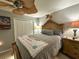 Bedroom features a bed with a detailed headboard, ceiling fan, and neutral decor at 13807 Eagles Rock Ct, Hudson, FL 34667
