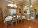 Formal dining room features hardwood floors and a chandelier, perfect for entertaining at 13807 Eagles Rock Ct, Hudson, FL 34667