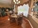 Formal dining area features natural light, hardwood flooring, and detailed trim at 13807 Eagles Rock Ct, Hudson, FL 34667