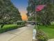 Long driveway leading to the home, complemented by a decorative lion statue and lush greenery at 13807 Eagles Rock Ct, Hudson, FL 34667