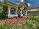 Charming front exterior with a decorative stained-glass window and manicured landscaping at 13807 Eagles Rock Ct, Hudson, FL 34667