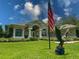 This home features a meticulously landscaped front yard, an American flag, and a patriotic eagle statue at 13807 Eagles Rock Ct, Hudson, FL 34667