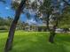 Traditional home with a well-maintained lawn and picturesque landscaping at 13807 Eagles Rock Ct, Hudson, FL 34667
