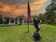 View of the home's facade, lawn, front landscaping, and patriotic decor at 13807 Eagles Rock Ct, Hudson, FL 34667