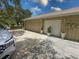Attached two-car garage with painted doors and a concrete driveway for convenient parking at 13807 Eagles Rock Ct, Hudson, FL 34667