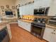 Updated kitchen with stainless steel appliances, granite countertops, and custom cabinets at 13807 Eagles Rock Ct, Hudson, FL 34667