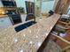 Kitchen island with sink, seating, granite counters and stainless appliances at 13807 Eagles Rock Ct, Hudson, FL 34667