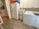 Functional laundry room features a washer, dryer, refrigerator, and ample storage space at 13807 Eagles Rock Ct, Hudson, FL 34667