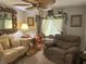 Inviting living room with large mirror, desk, couch and accent decor at 13807 Eagles Rock Ct, Hudson, FL 34667