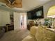Living room featuring decorative elements, a flat-screen television, and an adjacent workspace at 13807 Eagles Rock Ct, Hudson, FL 34667