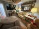 Comfortable living room with couch, desk, lamps, and a large mirror at 13807 Eagles Rock Ct, Hudson, FL 34667