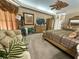 Main bedroom with sitting area, carpet, and natural lighting at 13807 Eagles Rock Ct, Hudson, FL 34667
