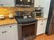 Close up of kitchen oven with stainless steel finish and granite countertop at 13807 Eagles Rock Ct, Hudson, FL 34667