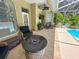 Outdoor living space with tiled floors, ceiling fan and comfortable seating by the pool at 13807 Eagles Rock Ct, Hudson, FL 34667