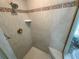 Tiled shower with a grab bar and corner seat at 13807 Eagles Rock Ct, Hudson, FL 34667