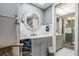 Well-lit bathroom with gray vanity and a decorative mirror at 147 Bluff View Dr # 105, Belleair Bluffs, FL 33770
