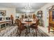 A cozy dining area featuring a round table and chairs, adjacent to the living room at 147 Bluff View Dr # 105, Belleair Bluffs, FL 33770