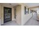 Exterior hallway shows unit 105 with a secure front door, black shutters, and outdoor lighting at 147 Bluff View Dr # 105, Belleair Bluffs, FL 33770