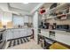 Kitchen with white cabinets, ample counter space, and an open shelving for storage at 147 Bluff View Dr # 105, Belleair Bluffs, FL 33770