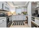 A functional white kitchen featuring modern appliances, neutral countertops, and ample cabinet space at 147 Bluff View Dr # 105, Belleair Bluffs, FL 33770