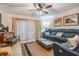 A comfortable living room features a blue sofa, neutral walls, and textured area rug at 147 Bluff View Dr # 105, Belleair Bluffs, FL 33770