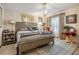 Cozy main bedroom featuring a decorative chandelier, carpeted floor, and a large bed at 147 Bluff View Dr # 105, Belleair Bluffs, FL 33770