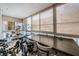 Enclosed sunroom features tile flooring and multiple bikes at 147 Bluff View Dr # 105, Belleair Bluffs, FL 33770