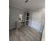 Bathroom features a vanity, built-in storage shelves, and wood-look flooring at 15591 Charmwood Dr, Hudson, FL 34667