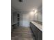 Bathroom with modern vanity, and wood-look flooring, offers a sleek design at 15591 Charmwood Dr, Hudson, FL 34667