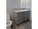 Cozy bathroom with a toilet and vanity with cabinet at 15591 Charmwood Dr, Hudson, FL 34667