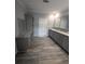 Bathroom with modern vanity, and wood-look flooring, offers a sleek design at 15591 Charmwood Dr, Hudson, FL 34667
