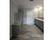 Bathroom with modern vanity, and wood-look flooring, offers a sleek design at 15591 Charmwood Dr, Hudson, FL 34667