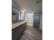 Large bathroom with double vanity, shower, toilet room, and makeup vanity at 15591 Charmwood Dr, Hudson, FL 34667