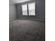 Bedroom with carpet, two windows, and neutral paint at 15591 Charmwood Dr, Hudson, FL 34667