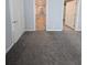 Bedroom view showcasing plush gray carpeting, with white doors and an entryway into a walk-in closet at 15591 Charmwood Dr, Hudson, FL 34667