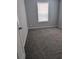 Neutral-toned bedroom offers carpeted floors and a window with lots of natural light at 15591 Charmwood Dr, Hudson, FL 34667