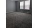 Bedroom with carpet, two windows, and neutral paint at 15591 Charmwood Dr, Hudson, FL 34667