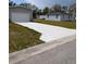 Wide concrete driveway leading to a spacious two-car garage, providing ample parking at 15591 Charmwood Dr, Hudson, FL 34667
